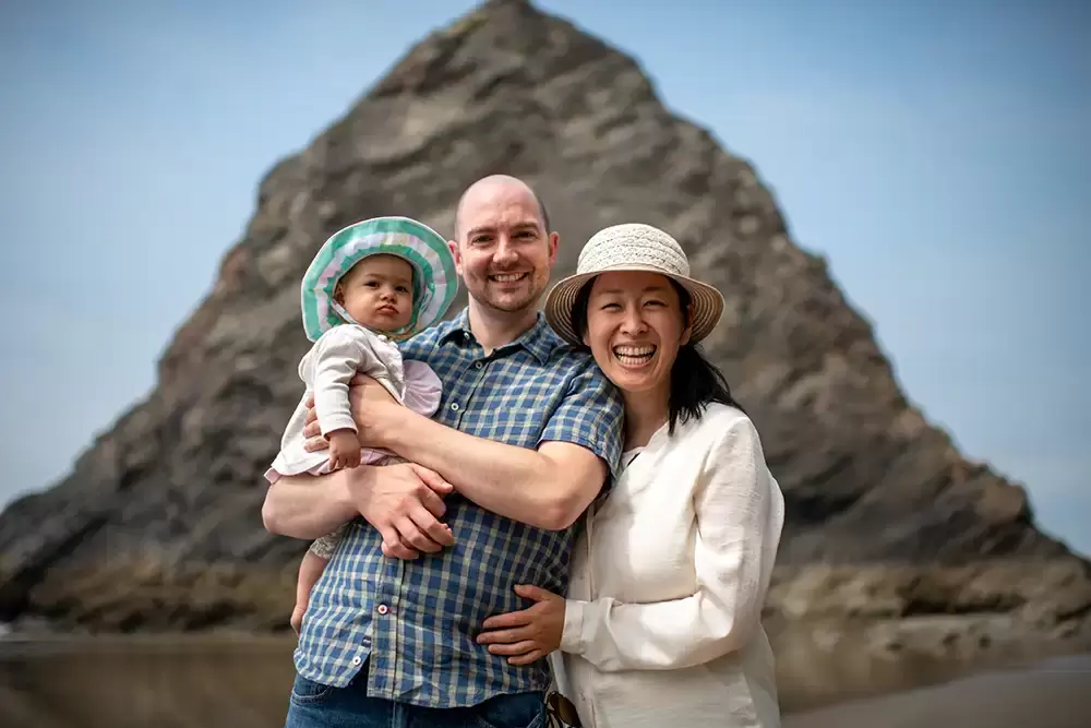 at the beach a family smiles to the camera Portland ​Family Photographer Robert Knapp - Book Today!