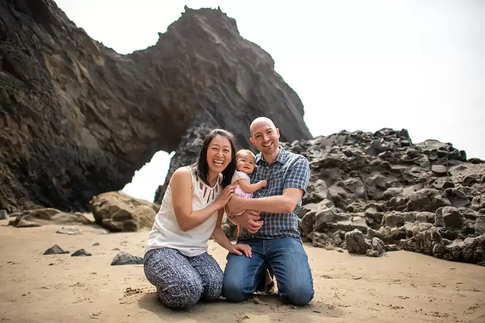 family photos on a rocky beach with mom dad and baby Portland ​Family Photographer Robert Knapp - Book Today!