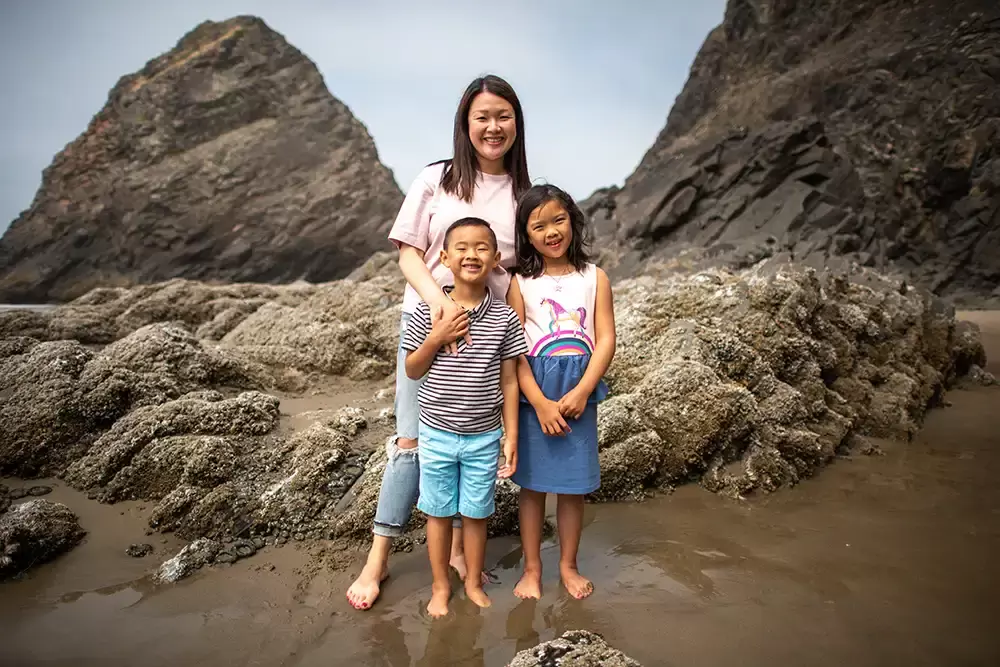 Mother poses with her children on the beach for a family photo in Cannon Beach Portland ​Family Photographer Robert Knapp - Book Today! ​Family Photographer Robert Knapp in Portland - Book Today!