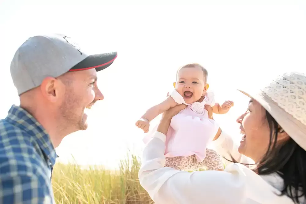 Baby is very happy. Finally, mother and father are happy to baby is held up in the sun. Portland ​Family Photographer Robert Knapp - Book Today!​Family Photographer Robert Knapp in Portland - Book Today!