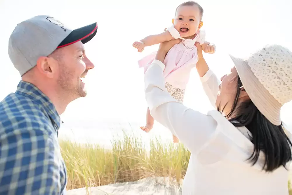 Mama holds up her happy baby mother and father are very happy to Portland ​Family Photographer Robert Knapp - Book Today! ​Family Photographer Robert Knapp in Portland - Book Today!