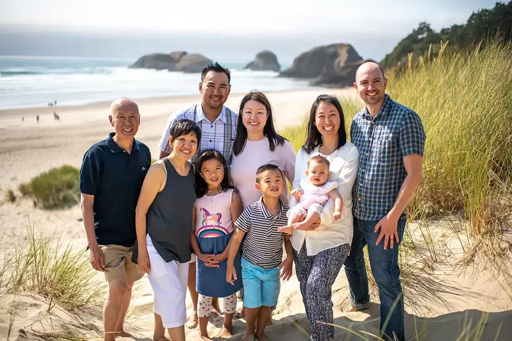 with cannon beach in the background this family poses for a portrait Portland ​Family Photographer Robert Knapp - Book Today!​Family Photographer Robert Knapp in Portland - Book Today!