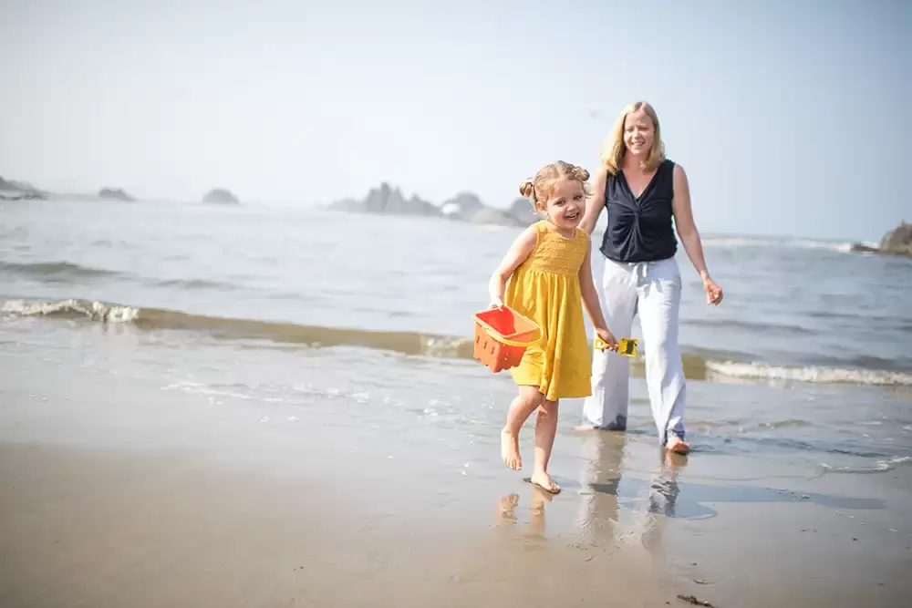 beach family picture ideas a little girl and her mother run though the wet sand next to the ocean.   Family Pictures Beach Theme with Portland Family Photographer Robert Knapp