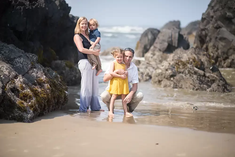 mother and father stand with their children on the beach and look to the camera   Family Pictures Beach Theme with Portland Family Photographer Robert Knapp