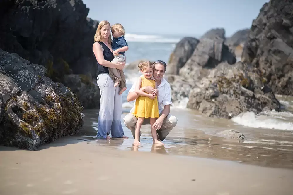 a family plays in the waves in their family photo   Family Pictures Beach Theme with Portland Family Photographer Robert Knapp