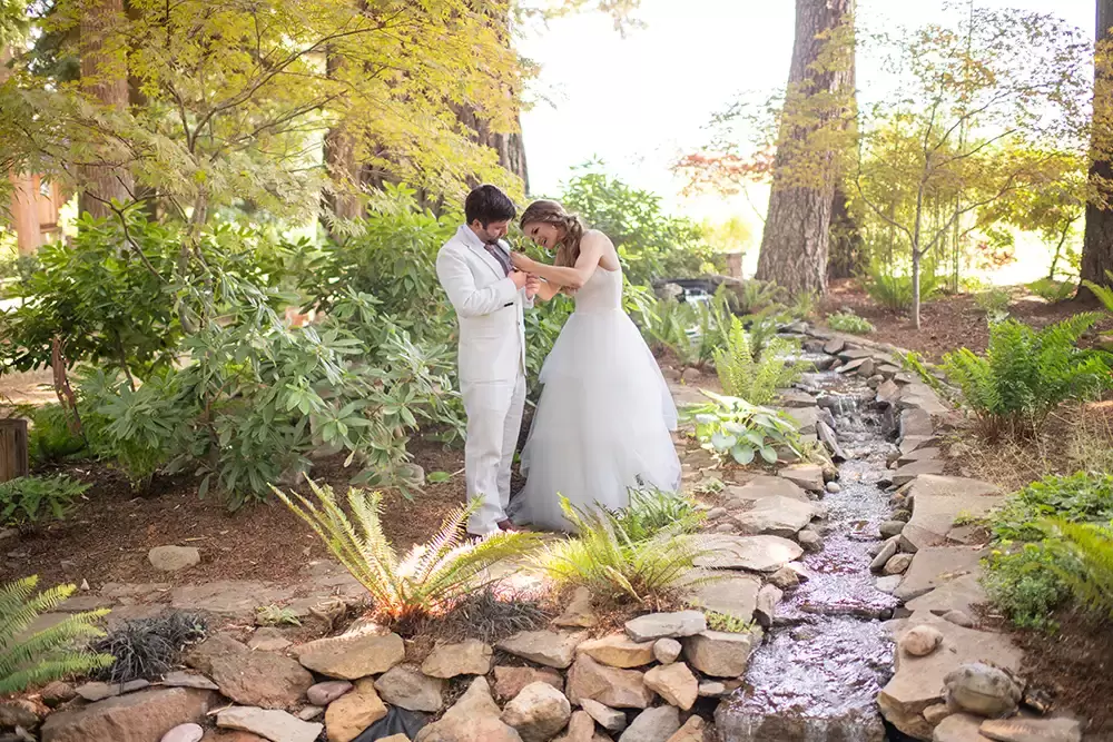 bride helps groom with flower Portland Oregon Wedding Photographer