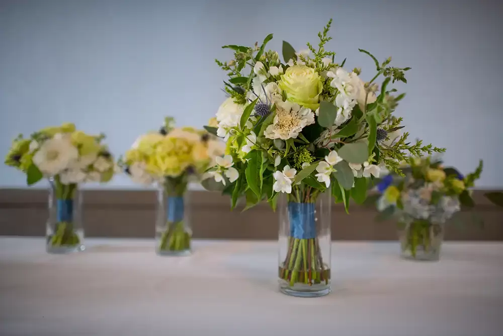 Polaris Hall
Portland Oregon Wedding Venue
Photographer Robert Knapp at Modern Art Photograph  the bouquets for the bride and bridesmaids sitting in glass jars on a table