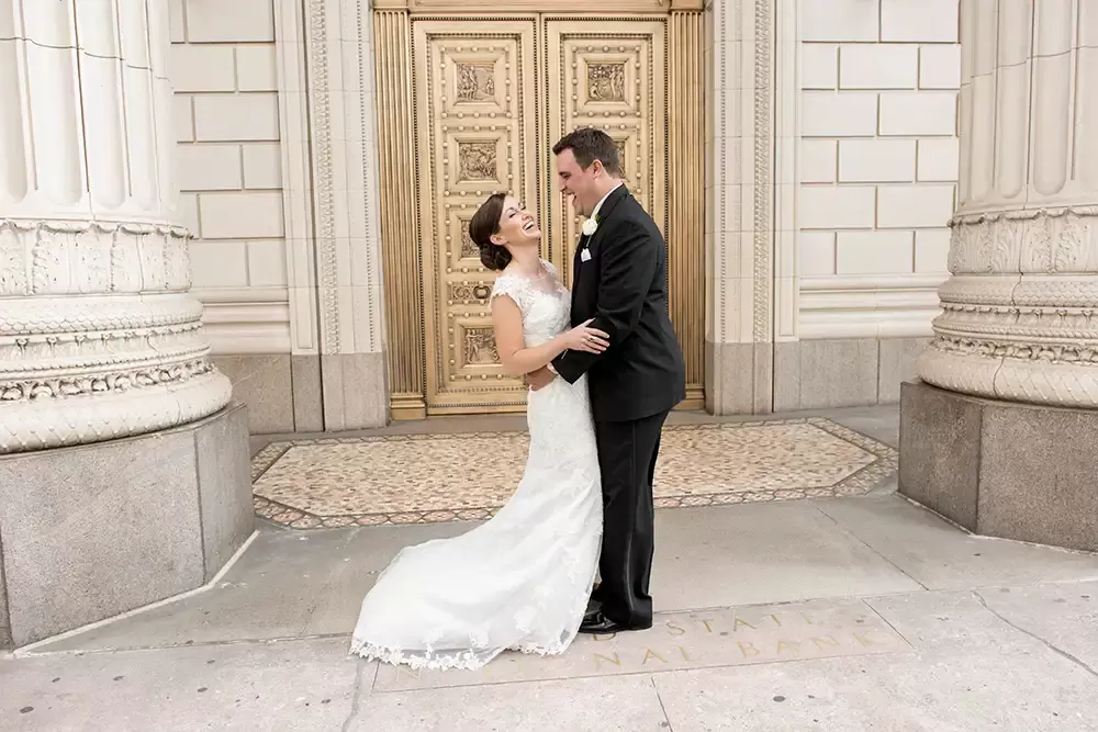 Portland Wedding Photographers at Modern Art Photograph The Photojournalist Wedding Photography of Robert Knapp capture a moment between a bride and groom in front of the treasury ballroom entrance