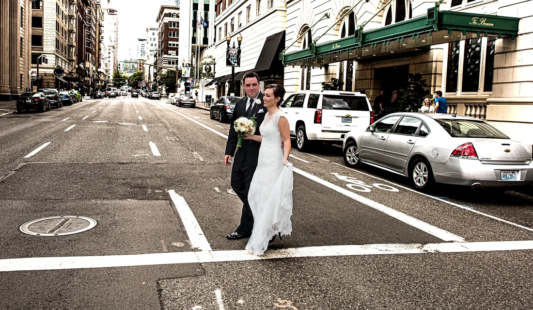 ​Portland Wedding Photographers at the Portland Benson Hotel Bride and groom cross the street in front of the benson hotel