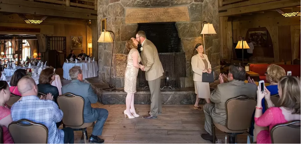 Wedding at timberline lodge, the groom kisses the bride during the ceremony. 