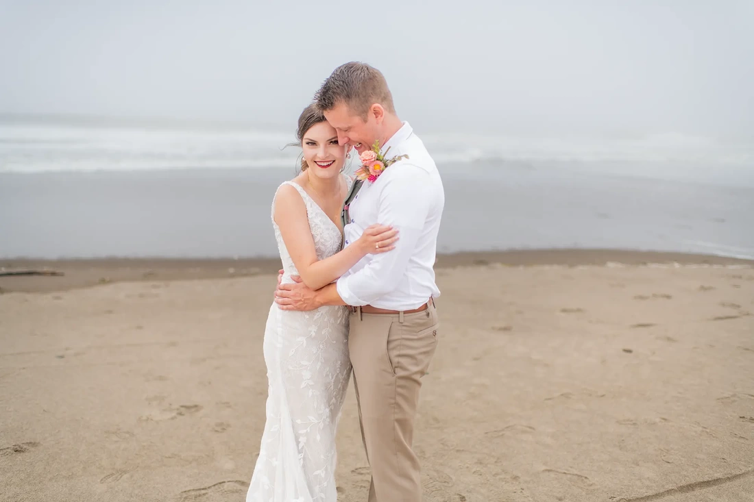 Salashan Wedding Photos With a First Look on the Beach from Photographer Robert Knapp Groom holding bride on the beach