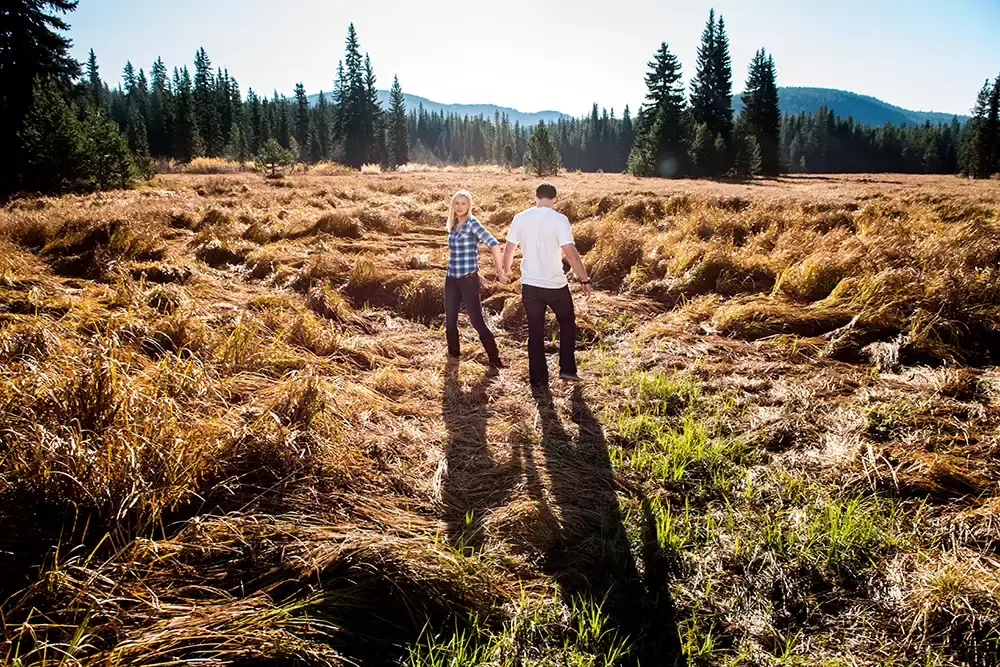 A couple stands in a highland meadow up in the mountains Unforgettable Moment - Mountain Engagement Photos 
with
​ Photojournalist Photographer Robert Knapp