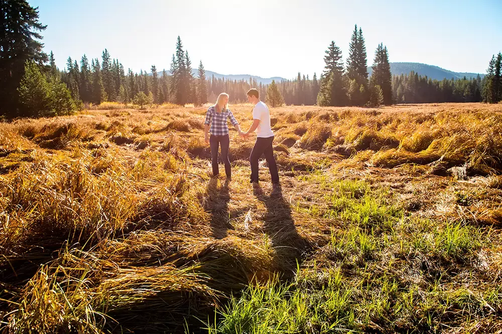 a couple stands in a natural meadow high in the mountains Unforgettable Moment - Mountain Engagement Photos 
with
​ Photojournalist Photographer Robert Knapp