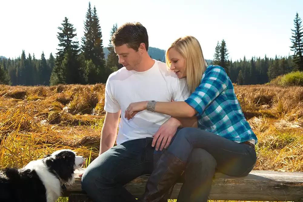 man and woman sit on a bench with a little collie dog walking around Unforgettable Moment - Mountain Engagement Photos 
with
​ Photojournalist Photographer Robert Knapp