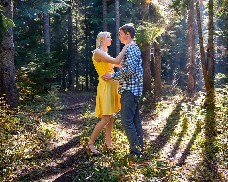 on an simple logging road a couple takes mountain engagement photos Unforgettable Moment - Mountain Engagement Photos 
with
​ Photojournalist Photographer Robert Knapp