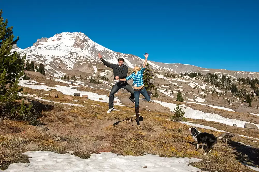 mountain engagement photos of a couple jumping in the air. Their dog is getting excited. Unforgettable Moment - Mountain Engagement Photos 
with
​ Photojournalist Photographer Robert Knapp