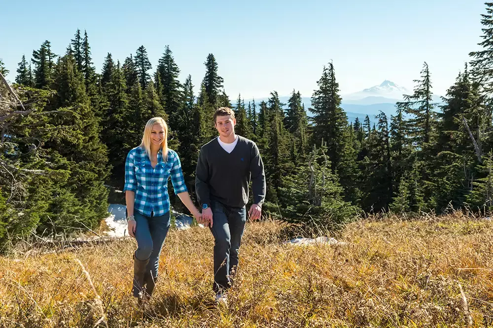 mountain engagement photos of a couple holding hands and walking to the camera Unforgettable Moment - Mountain Engagement Photos 
with
​ Photojournalist Photographer Robert Knapp