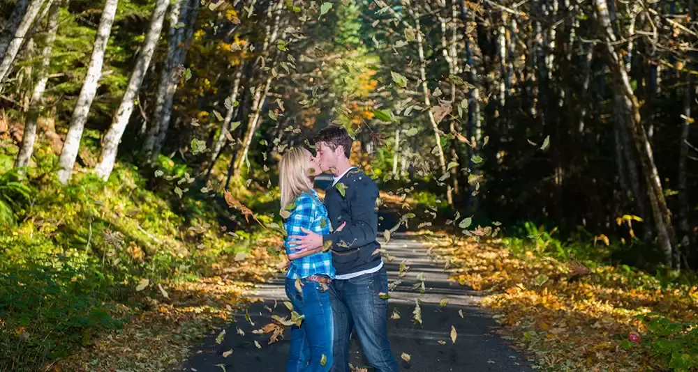 mountain engagement photos autumn style, leafs falling, a couple kisses Unforgettable Moment - Mountain Engagement Photos 
with
​ Photojournalist Photographer Robert Knapp