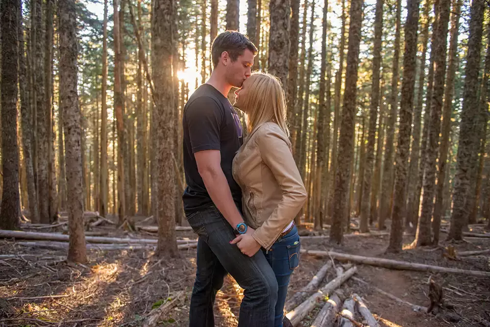 mountain engagement photos of a couple kissing in the sunset light of the forest Unforgettable Moment - Mountain Engagement Photos 
with
​ Photojournalist Photographer Robert Knapp