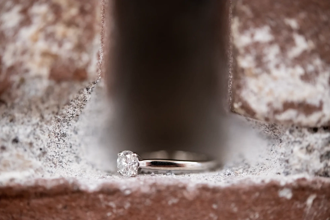 Wedding Photographers in Portland  at the EcoTrust Robert Knapp Photographer the engagement ring sits in the brick wall, photographed with a macro lens the stone is impressive 