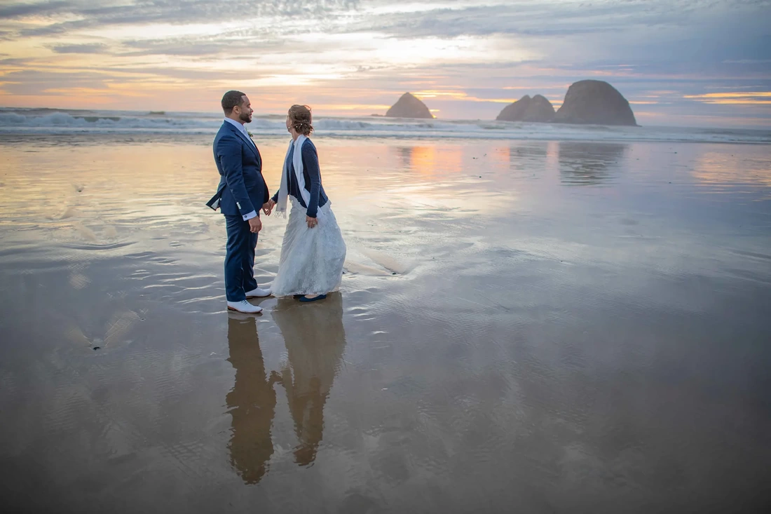 Wedding Photographers Near Me | Modern Art Photograph Wedding Photography from Oceanside, Oregon On the wet sand at Oceanside oregon a bride and groom stand at sunset. Wedding Photography from Oceanside, Oregon Wedding Photographers Near Me 