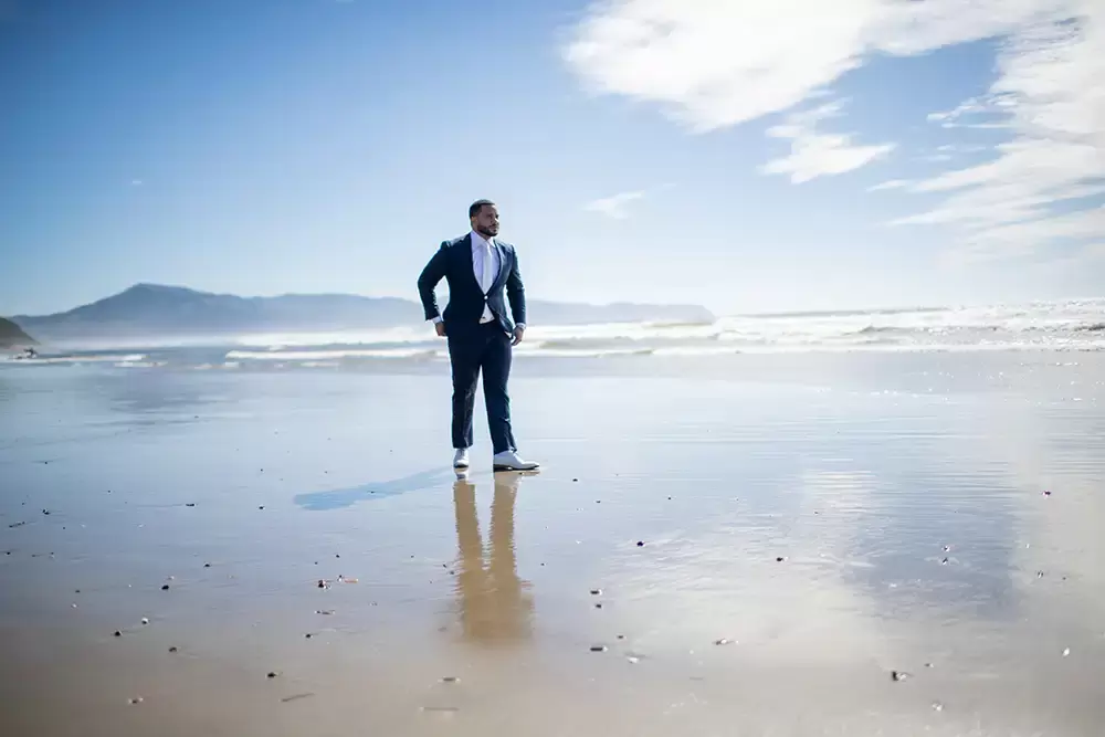 Wedding Photographers Near Me | Modern Art Photograph
Wedding Photography
from Oceanside, Oregon groom stands in the wet sand reflecting his image, the blue sky and some clouds 
