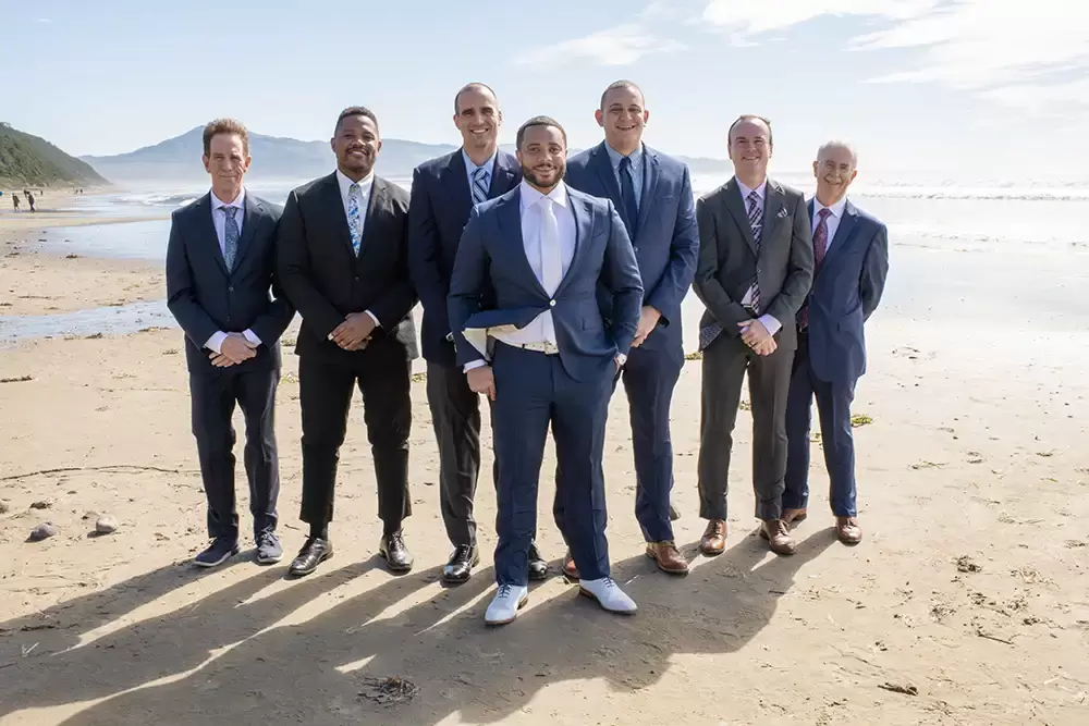 Wedding Photographers Near Me | Modern Art Photograph
Wedding Photography
from Oceanside, Oregon groom and groomsmen remove their sunglasses for a photo in the V formation