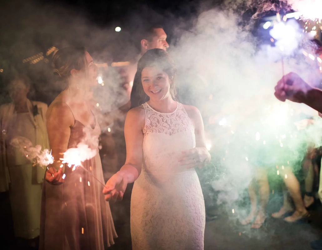 Opal 28 ​Wedding Photography from Robert Knapp Photographer bride holds a sparkler at the formal send off Wedding Photography from Opal 28 Robert Knapp photographer at Opal28 