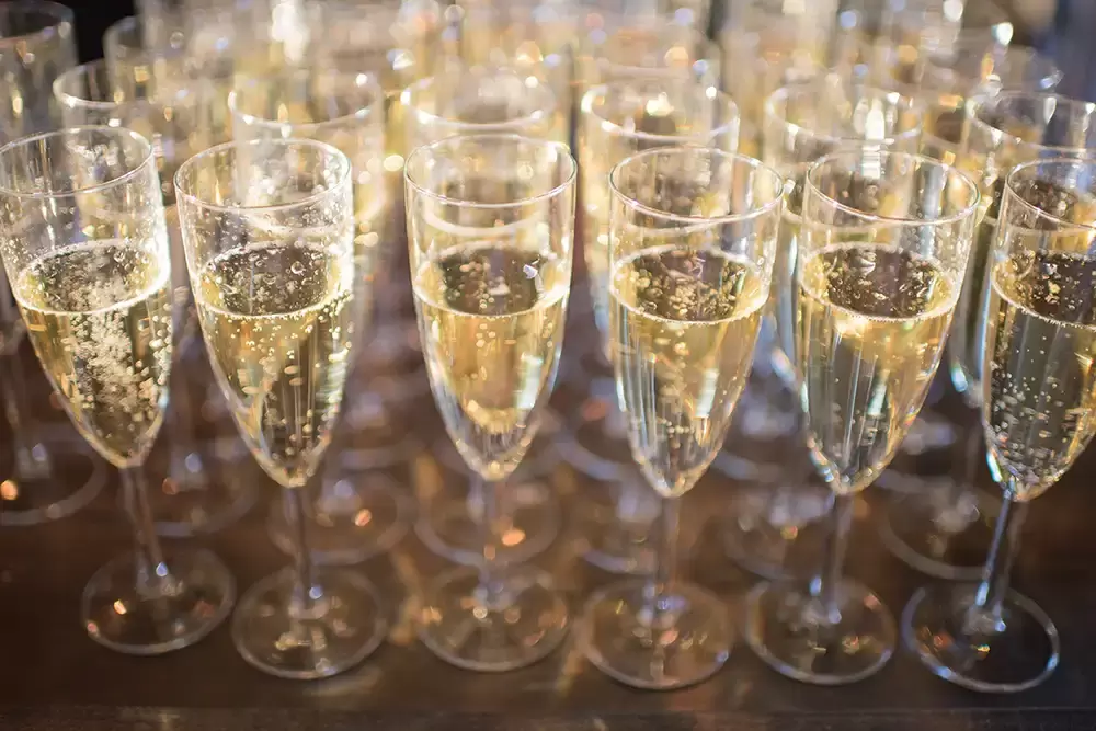 Tin Roof Weddings Barn Weddings Venues Near Me from Photographer Robert Knapp They close up of many glasses of champagne for the toast