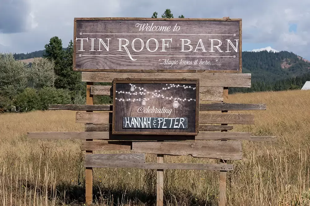 Tin Roof Weddings Barn Weddings Venues Near Me from Photographer Robert Knapp A picture of the sign of the wedding venue, tin roof barn. Additionally, a sign for the guests, welcoming Hannah and Peter's wedding.