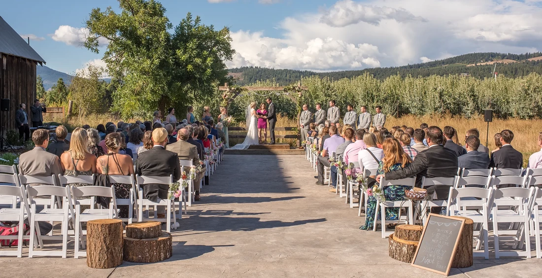 Tin Roof Weddings Barn Weddings Venues Near Me from Photographer Robert Knapp The ceremony is happening in this photos. The barn to the left, an orchard, mountains and interesting clouds in the distance. Tin Roof Weddings Barn Weddings Venues Near Me